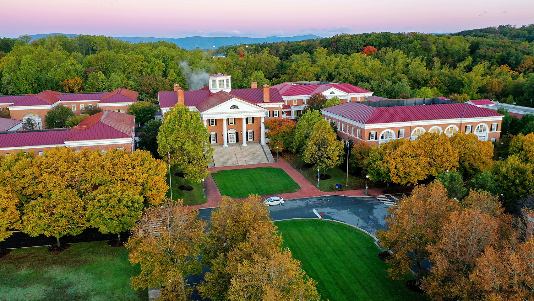 a Darden School of Business building surrounded by trees