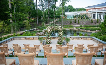 outdoor wedding stage setup with hotel in background