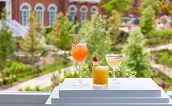 cocktails on a table with the hotel in the background