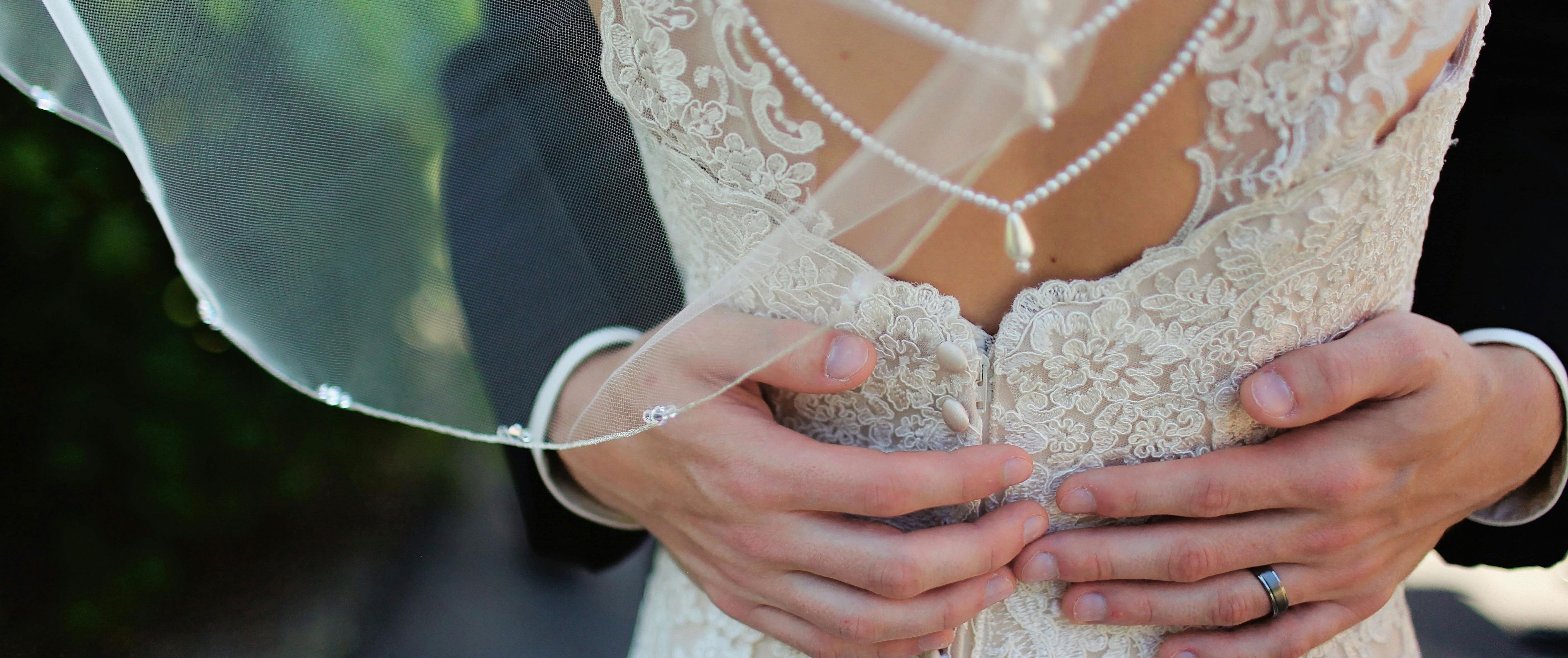 grooms hands around bride